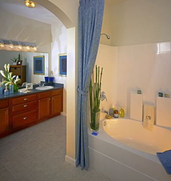 a bathroom with a tub and a sink